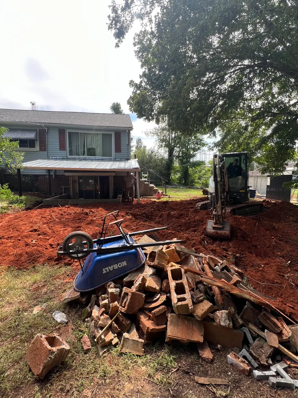 Excavation underway behind the home ahead of drainage and waterproofing work