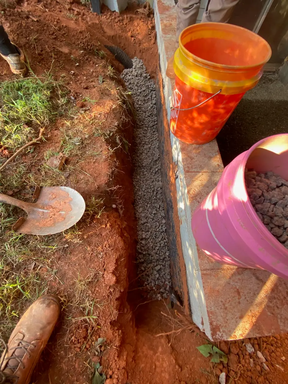 French drain installation behind the home