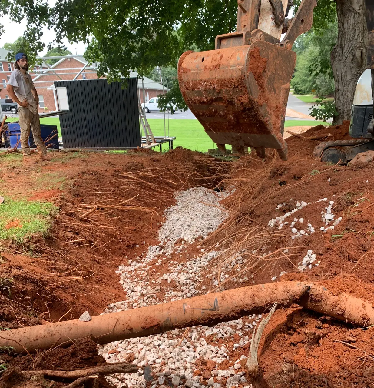 French drain installation continuing along the foundation
