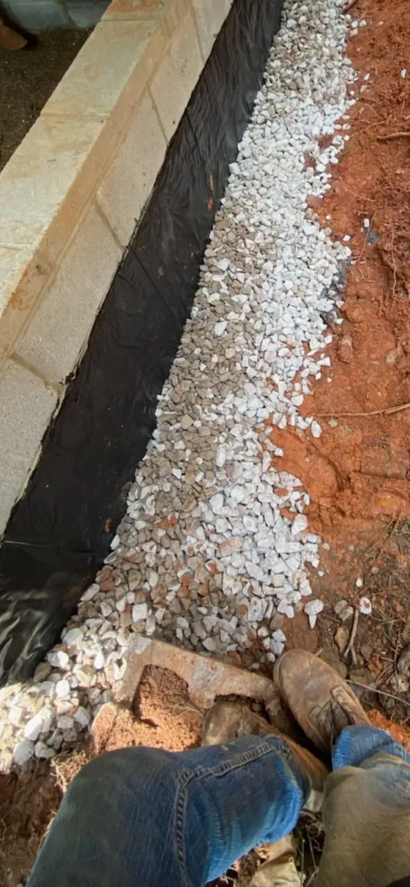 Exterior block foundation wall being waterproofed