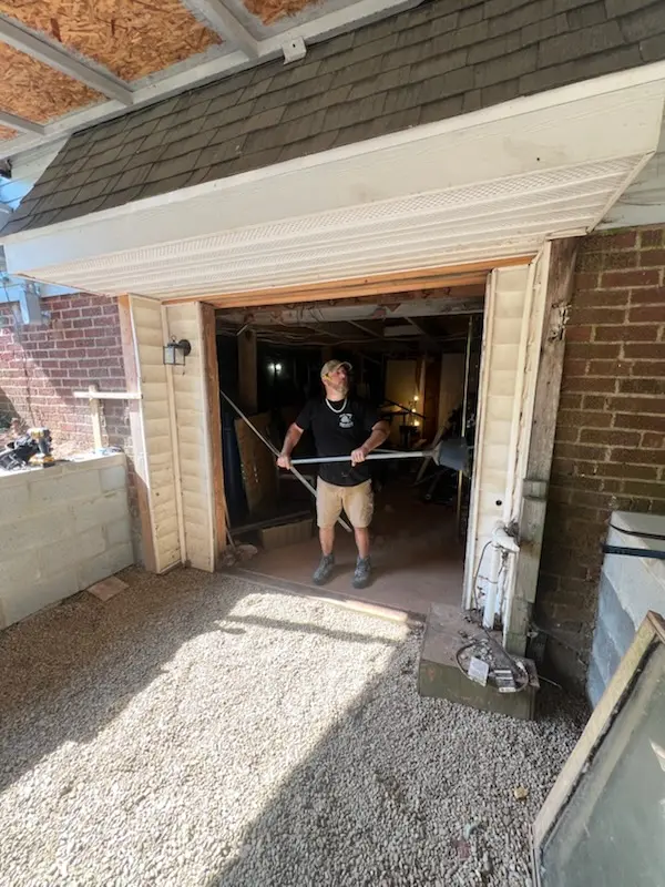 Contractor at the rear entrance opening during installation of the new door
